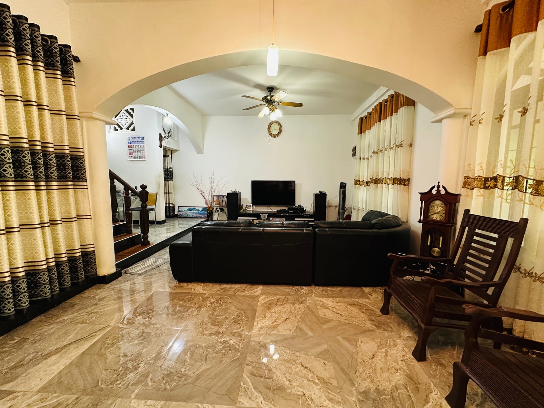 Shared living room with arched openings and timber seating